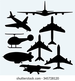 Set jets, dirigible, helicopter. Isolated on blue background. Vector silhouettes