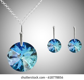 A set of jewelry. The chain and earrings, round in blue. Set decoration on a gray background.