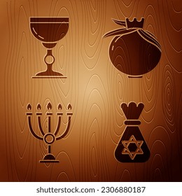 Set Jewish money bag with star of david, Jewish goblet, Hanukkah menorah and Pomegranate on wooden background. Vector
