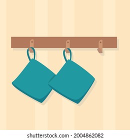A set of kitchen mittens hangs in the kitchen. Kitchen potholders. Flat vector illustration.