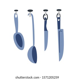 A set of kitchen utensils for cooking, knives, spoons weigh on cloves.