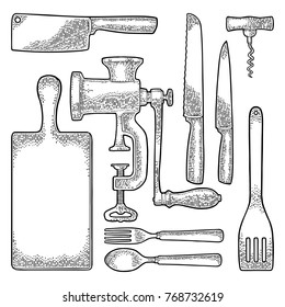 Set Kitchen utensils. Wood cutting board, manual meat grinder, spade of frying pan, knifes, spoon, fork. Vector black vintage engraving illustration for menu, poster. Isolated on white background