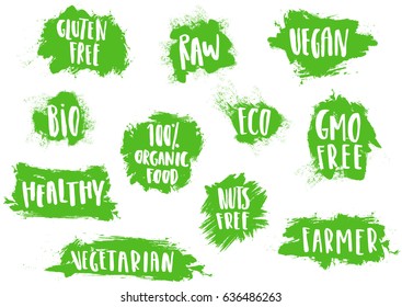 Set of labels, tags, logos with handwritten lettering for bio, eco, organic foods and vegetables. White inscriptions on green semi-dry brush strokes.