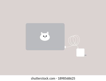 A set of laptop and power adapter set, a cute cat head sticker on top of the computer, workplace, isolated objects on plain background