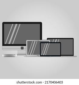 set of laptops and computers in gray