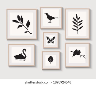Set of light braun wood frames with shadow on gray wall for interior design. Collection of decorative bird, stems, leaf, butterfly silhouette. Vector stock illustration.