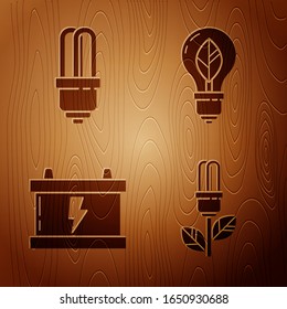 Set Light bulb with leaf, LED light bulb, Car battery and Light bulb with leaf on wooden background. Vector