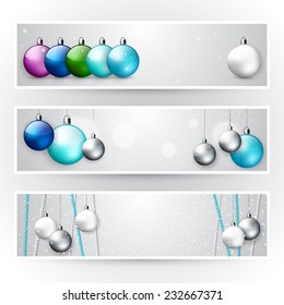 Set of light elegant Christmas horizontal banners; winter holiday flyer with Christmas shiny  balls and snow; vector template with place for text