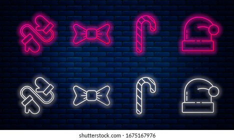 Set line Bow tie, Christmas candy cane with stripes, Pair of knitted christmas mittens and Christmas Santa Claus hat. Glowing neon icon on brick wall. Vector