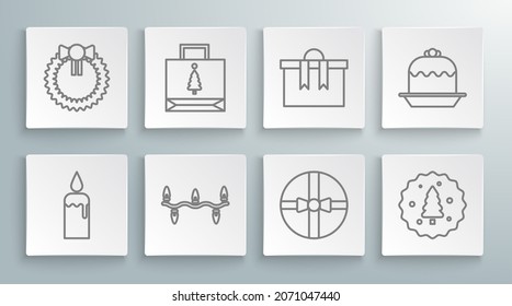 Set line Burning candle in candlestick, Christmas paper shopping bag, lights, Gift box, Cookie or biscuit with chocolate, Cake and wreath icon. Vector