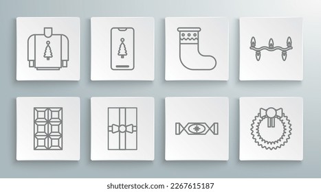 Set line Chocolate bar, Smartphone with gift box, Gift, Candy, Christmas wreath, stocking, lights and sweater icon. Vector