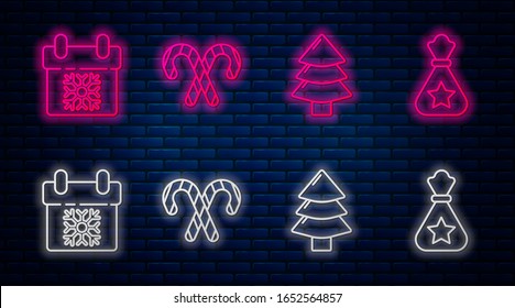Set line Christmas candy cane with stripes, Christmas tree, Calendar and Santa Claus bag gift. Glowing neon icon on brick wall. Vector