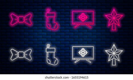 Set line Christmas stocking, Merry Christmas on television, Bow tie and Christmas star. Glowing neon icon on brick wall. Vector