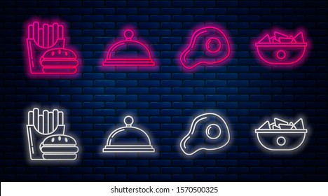 Set line Covered with a tray of food, Scrambled eggs, Burger and french fries in carton package box and Nachos in plate. Glowing neon icon on brick wall. Vector