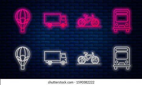 Set line Delivery cargo truck vehicle, Bicycle, Hot air balloon and Bus. Glowing neon icon on brick wall. Vector