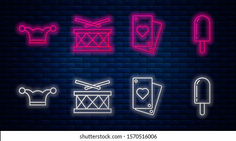 Set line Drum with drum sticks, Playing card, Jester hat with bells and Ice cream. Glowing neon icon on brick wall. Vector