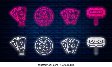 Set line Glass of whiskey and ice cubes, Playing cards, Hand holding playing cards and Casino signboard. Glowing neon icon on brick wall. Vector