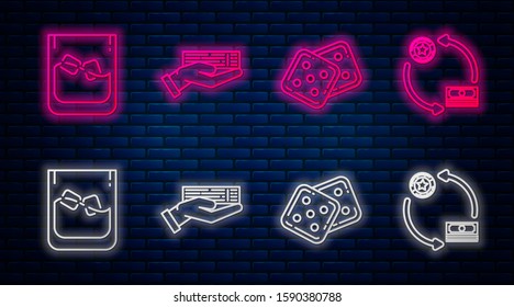 Set line Hand holding deck of playing cards, Game dice, Glass of whiskey and ice cubes and Casino chips exchange on stacks of dollars. Glowing neon icon on brick wall. Vector