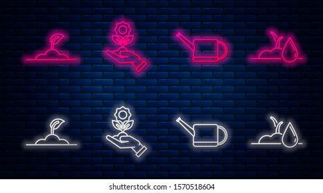 Set line Hand holding flower, Watering can, Sprout and Watering sprout. Glowing neon icon on brick wall. Vector