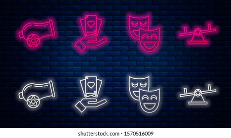 Set line Hand holding playing cards, Comedy theatrical masks, Cannon and Seesaw. Glowing neon icon on brick wall. Vector