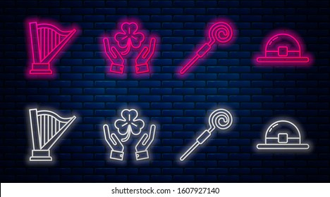 Set line Human hands holding four leaf clover, Walking stick, Harp and Leprechaun hat. Glowing neon icon on brick wall. Vector