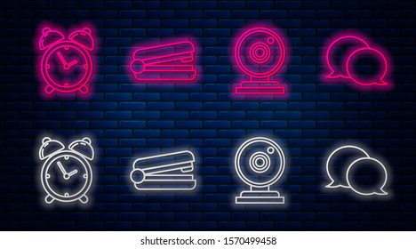 Set line Office stapler, Web camera, Alarm clock and Speech bubble chat. Glowing neon icon on brick wall. Vector