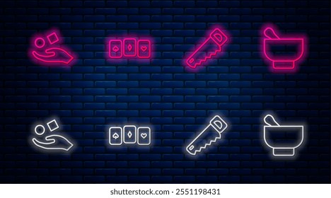 Set line Playing cards, Hand saw, Cube levitating above hand and Magic mortar pestle. Glowing neon icon on brick wall. Vector