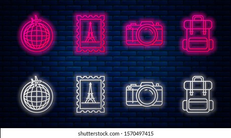 Set line Postal stamp and Eiffel tower, Photo camera, Globe with flying plane and Hiking backpack. Glowing neon icon on brick wall. Vector