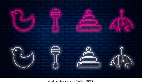 Set line Rattle baby toy, Pyramid toy, Rubber duck and Baby crib hanging toys. Glowing neon icon on brick wall. Vector