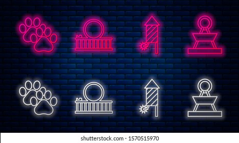 Set line Roller coaster, Firework rocket, Paw print and Attraction carousel. Glowing neon icon on brick wall. Vector