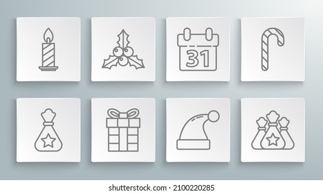 Set line Santa Claus bag gift, Branch viburnum or guelder rose, Gift box, Christmas hat, Calendar, candy cane with stripes and Burning candle in candlestick icon. Vector