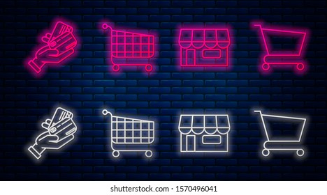 Set line Shopping cart, Shopping building or market store, Human hand holding with credit card and Shopping cart. Glowing neon icon on brick wall. Vector