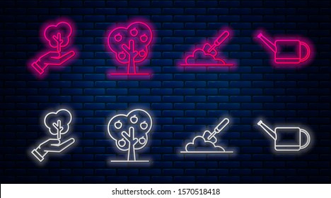 Set line Tree with apple, Garden trowel spade or shovel in the ground, Tree in hand of environmental protection and Watering can. Glowing neon icon on brick wall. Vector