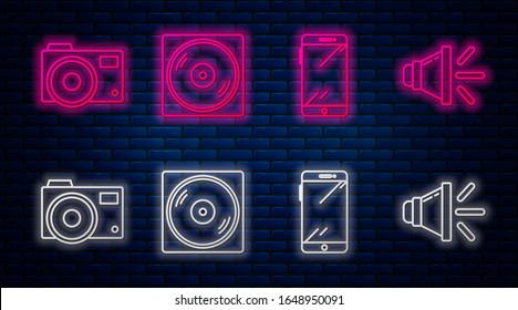 Set line Vinyl disk, Smartphone, mobile phone, Photo camera and Speaker volume. Glowing neon icon on brick wall. Vector
