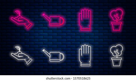 Set line Watering can, Garden gloves, Sprout in hand of environmental protection and Tree in pot. Glowing neon icon on brick wall. Vector