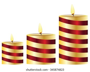Set of lit candles in different sizes.