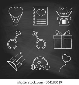 Set of love icons painted with white chalk on a blackboard. Decorative icons for Valentine's day. Hands-drawn style.