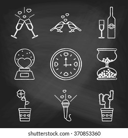 Set of love icons painted with white chalk on a blackboard. Decorative icons for Valentine's day. Hands-drawn style