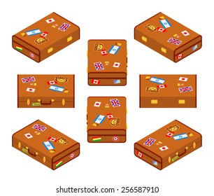 Set of lying brown travelers suitcases with the stickers. The objects are isolated against the white background and shown from different sides