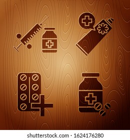 Set Medicine bottle and pills, Medical syringe with needle and vial or ampoule, Pills in blister pack and Ointment cream tube medicine on wooden background. Vector