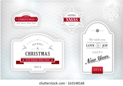 Set of "Merry Christmas and Happy New Year" labels and snowflakes in elegant shades of gray, silver, white and red on textured silver background with light effects. Vector.