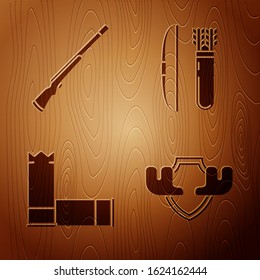 Set Moose horns on shield, Hunting gun, Cartridges and Bow and arrow in quiver on wooden background. Vector