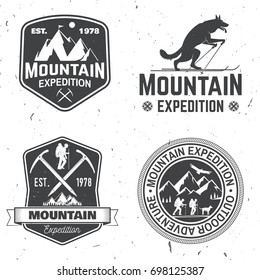 Set of mountain expedition badges. Vector illustration. Concept for shirt or logo, print, stamp or tee. Vintage typography design with mountaineers and mountain silhouette. Outdoors adventure emblems.