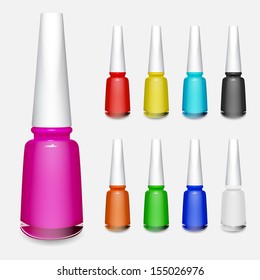 Set of multicolored bottles of nail polish on white background