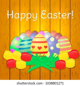 Set of multi-colored Easter eggs, a bouquet of yellow and red tulips on a wood texture background. Happy easter.
