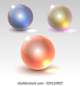 a set of multi-colored glass spheres on a light background