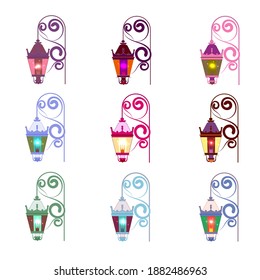 Set of multicolored vintage outdoor pendant lights, glowing. With curled cast iron wall mount.