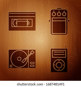 Set Music MP3 player, VHS video cassette tape, Vinyl player with a vinyl disk and Guitar pedal on wooden background. Vector