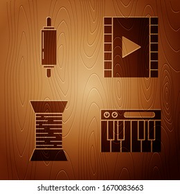Set Music synthesizer, Rolling pin, Sewing thread on spool and Play Video on wooden background. Vector