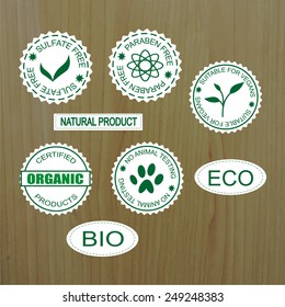 Set of Natural Organic product badges on wood background.